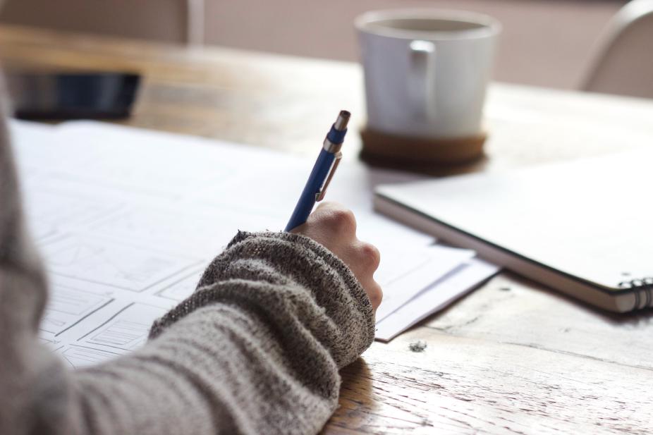 A person taking notes at a desk