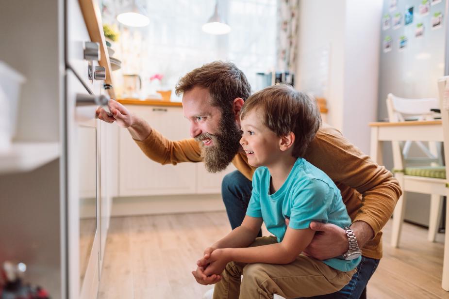 Homeowner adjusting smart thermostat to save on electric bill and reduce energy costs